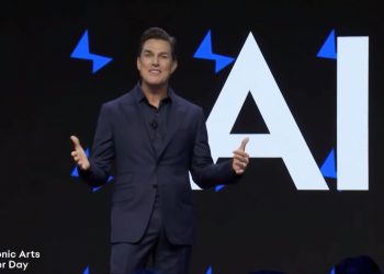 Andrew Wilson in front of a screen displaying "AI"